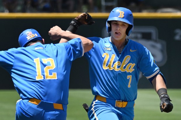 Niko Gallegov congratulates UCLA's Roman Martin on his home run in the third inning on May 30, 2025, in Los Angeles. (AP Photo/John McCoy)