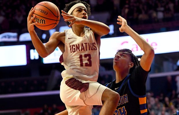 St. Ignatius guard Phoenix Gill goes in for a layup past Simeon's Miles Rubin on March 10, 2023, in an IHSA Class 3A state semifinal at the State Farm Center in Champaign. (Rob Dicker/Chicago Tribune)