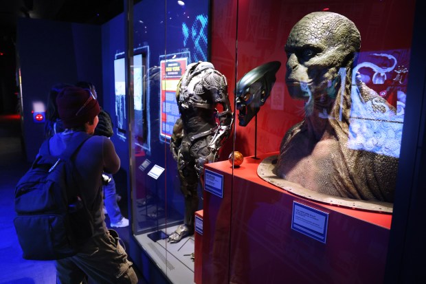Movie props including a Lizard head sculpture and a Green Goblin mask are included in the exhibition "Marvel's Spider-Man: Beyond Amazing" at the Griffin Museum of Science and Industry on May 22, 2025. (Terrence Antonio James/Chicago Tribune)