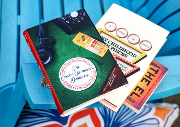 Three local books from top to bottom, "The Gossip Columnist's Daughter" by Peter Orner, "My Childhood in Pieces: A Stand-Up Comedy, a Skokie Elegy" by Edward Hirsch, and "The El" by Theodore C. Van Alst Jr. on June 2, 2025, in Barrington. (Stacey Wescott/Chicago Tribune)