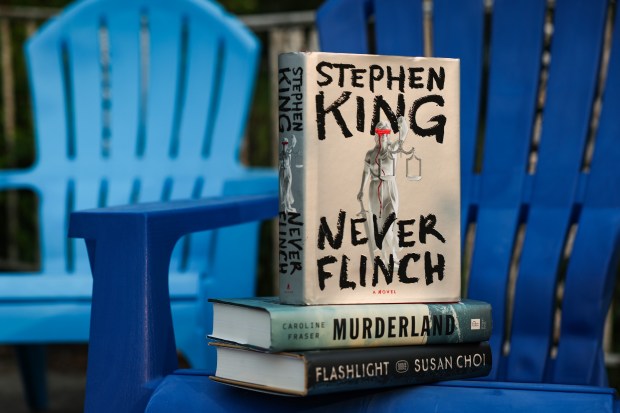Top to bottom, "Never Flinch" by Stephen King, "Murderland: Crime and Bloodlust in the Time of Serial Killers" by Caroline Fraser, and "Flashlight" by Susan Choi. (Stacey Wescott/Chicago Tribune)