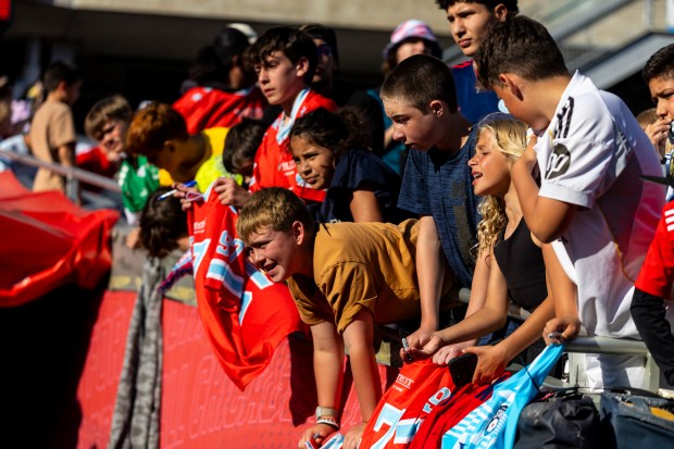 Young fans hang over the railing where Fire and Stars players left and entered the field Saturday, June 14, 2025, at Solder Field. (Vincent D. Johnson/for the Chicago Tribune)