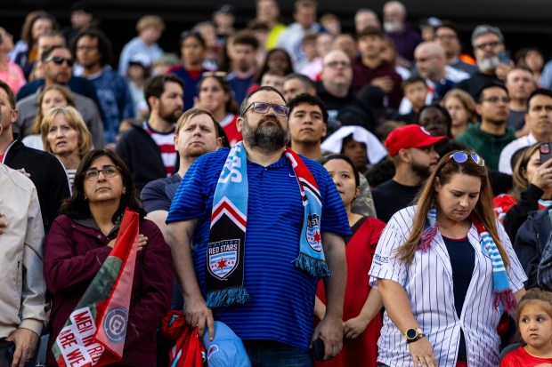 Fire fans stand during the national anthem Saturday, June 14, 2025, at Solder Field. (Vincent D. Johnson/for the Chicago Tribune)