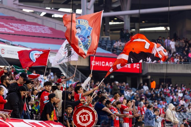 Members of the "Section Latino" wave flags and bang on drums as the Fire start their game against Nashville on Saturday, June 14, 2025, at Solder Field. (Vincent D. Johnson/for the Chicago Tribune)
