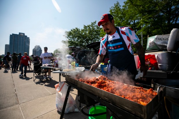 Jesus Valadez cooks meat at the Waldron parking deck before the Stars-Fire doubleheader Saturday, June 14, 2025, at Solder Field. (Vincent D. Johnson/for the Chicago Tribune)