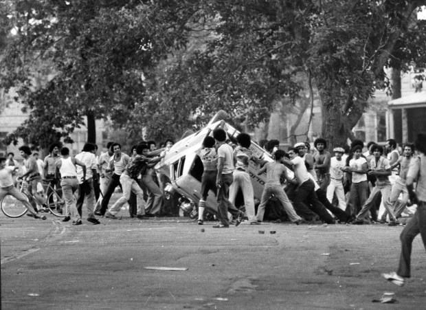 Rioters turn over a police car on June 5, 1977, near Division Street and California Avenue, just south east of Humboldt Park. Moments later, the car was set on fire and destroyed. (John BartleyChicago Tribune)