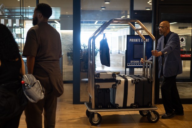Ernest Fizer, the head bellman at Sable Navy Pier, helps guests with luggage, June 6, 2025. (Audrey Richardson/Chicago Tribune)
