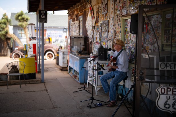 Ray Rose eases into an afternoon of busking on the porch of the Hackberry General Store in Hackberry, Arizona, on Route 66, June 6, 2025. (E. Jason Wambsgans/Chicago Tribune)