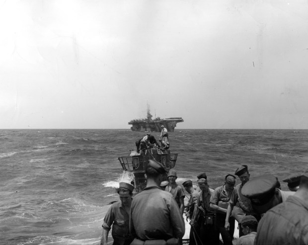 The USS Guadalcanal moves in to take on the towing line from the captured U-505 German submarine in June 1944. (U.S. Navy)