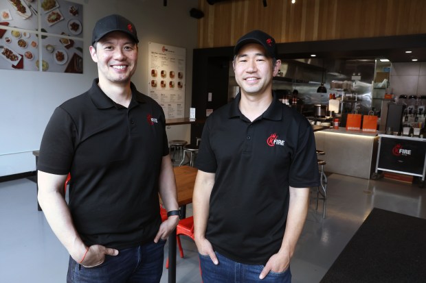 Eddie Hwang, left, and Ben Kim pose for a portrait at their restaurant, KFire, on June 2, 2025. The food delivery company Grubhub gave the restaurant an "Established 2020" award because it was started during Covid and made it to its fifth anniversary. (Terrence Antonio James/Chicago Tribune)
