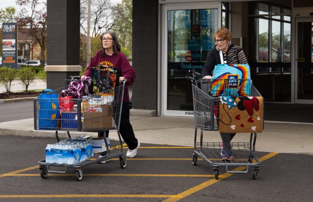 Donna Louise Shey, left, and Gloryana Angus leave an Aldi on May 2, 2025, in Morton Grove. (Audrey Richardson/Chicago Tribune)