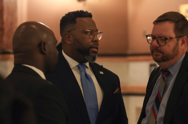 State Rep. Kam Buckner, center, talks with colleagues at the Illinois State Capitol on May 29, 2025, in Springfield. (John J. Kim/Chicago Tribune)