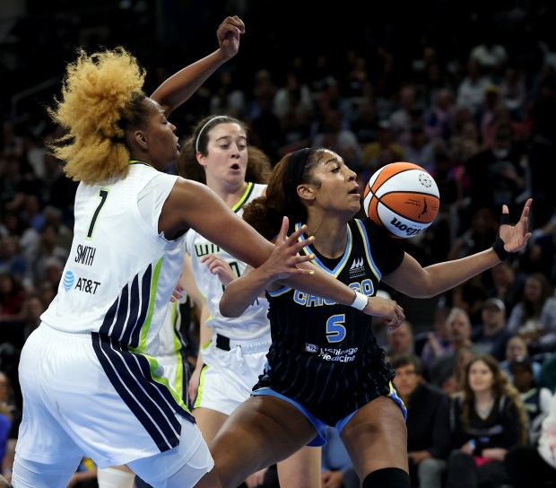 Sky forward Angel Reese (5) tries to collect the ball after having her shot blocked by Wings forward NaLyssa Smith (1) on May 29, 2025, at Wintrust Arena. (Chris Sweda/Chicago Tribune)
