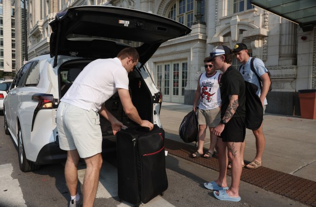 A ride-share driver loads luggage into his vehicle outside a hotel in the 1800 block of West Harrison Street, June 10, 2025, in Chicago. (John J. Kim/Chicago Tribune)