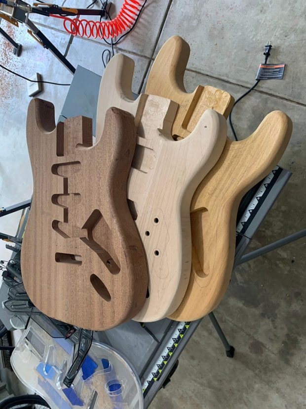 These are a few examples of the wooden bodies that can be transformed into custom-made guitars. The person who orders one can select everything from the type of wood used to the fret height, hardware, finish color and other features. (Penguin Guitar Co.)
