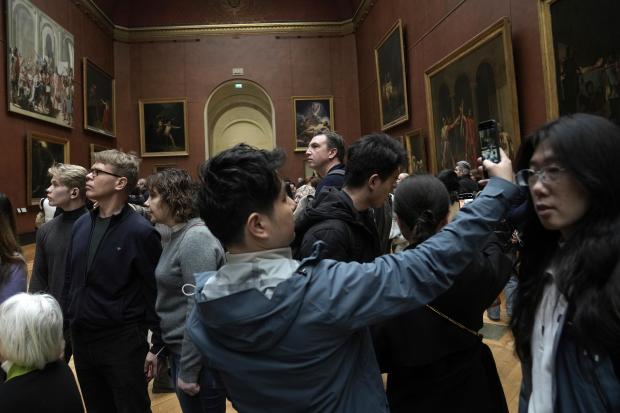 People visit the Louvre museum, Jan. 27, 2025 in Paris. (AP Photo/Thibault Camus)