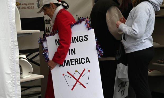 Messages from the No Kings protest a few blocks away at Highland Park City Hall are apparent among festival patrons at Arts on Sheridan in Highland Park on Saturday, June 14, 2025. (Karie Angell Luc/Lake County News-Sun)