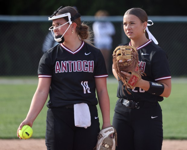 Antioch first baseman Sam Hillner visits pitcher Stella Dohrmann