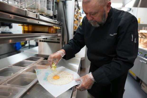 Charles L. Krumsiek, a McDonald's chef, makes a snack wrap (ranch) at McDonald's Headquarter in Chicago, Thursday, May 29, 2025. (AP Photo/Nam Y. Huh)