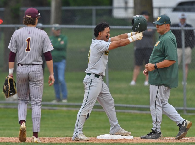 Waubonsie Valley's Hiroshy Wong (middle) reacts towards the dugout after hitting a first inning base hit against Lockport during a Class 4A Lockport Sectional semifinal game on Thursday, June 5, 2025 in Lockport.(Jon Cunningham/for The Naperville Sun)