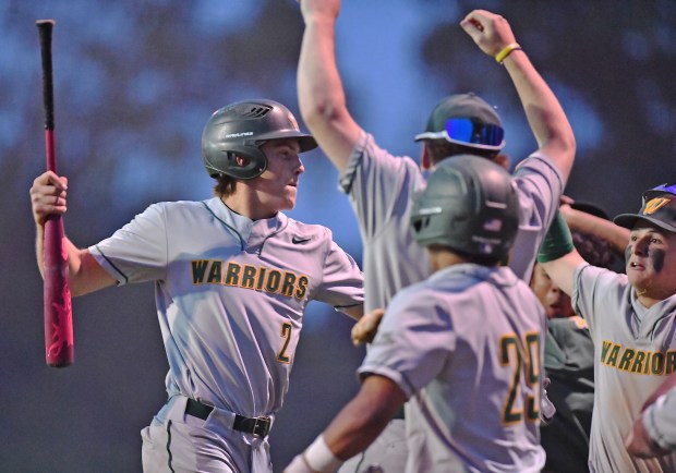 Waubonsie Valley's Owen Roberts arrives at the dugout after slugging a long home run off of the scoreboard in left field against Lockport during a Class 4A Lockport Sectional semifinal game on Thursday, June 5, 2025 in Lockport.(Jon Cunningham/for The Naperville Sun)