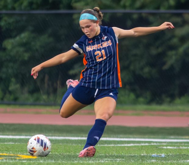 Naperville North's Emily Buescher passes the ball