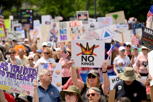 A crowd of thousands carrying signs and chanting gather outside the Naperville Municipal Center Saturday, June 14, 2025, for a "No Kings" protest before marching the downtown streets of Naperville. (Mark Black/for the Naperville Sun)