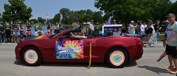 Motorist Chris Woodard and pedestrian Susan Goedke, both of Mundelein, co-founders of the Mundelein LGBT Alliance and Allies, take part in the 2025 Buffalo Grove Pride Parade on June 1, 2025 in Buffalo Grove. (Karie Angell Luc/Pioneer Press)