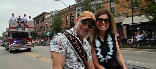 Parade Grand Marshal Brian Grano of Libertyville, owner of Mickey Finn's Brewery of Libertyville, rides with his wife Jetta Grano on Milwaukee Avenue at the 2025 Libertyville Days Parade on June 14, 2025 in downtown Libertyville. (Karie Angell Luc/Pioneer Press)