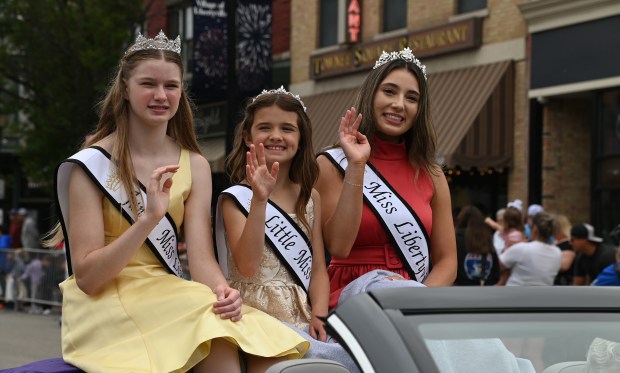 Libertyville Royalty 2025. From left to right are Audrey Byers, Campbell Ziemann and Miss Libertyville 2025 Ashley Rojas riding in an open convertible on the Milwaukee Avenue parade route for the 2025 Libertyville Days Parade on June 14, 2025 in downtown Libertyville. (Karie Angell Luc/Pioneer Press)