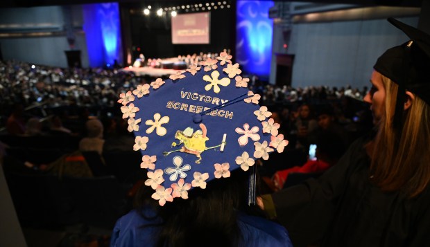 Waiting for the signal to enter the auditorium is Angelica Richalle Morandarte Rubio of Des Plaines at Maine East High School's graduation in Rosemont on May 18, 2025 at the Rosemont Theatre (5400 N. River Road). (Karie Angell Luc/Pioneer Press)