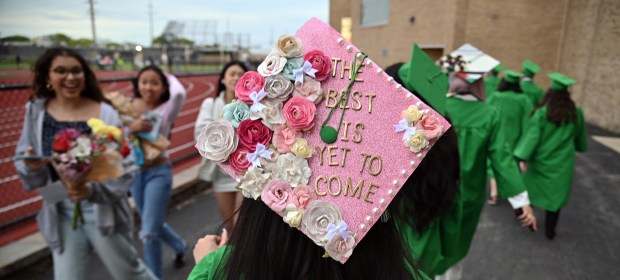 The best is yet to come. Talia Abuein of Harwood Heights is greeted by attendees while walking into the Daniel R. Romito Athletic Field for Commencement 2025 on May 27, 2025 at Ridgewood High School in Norridge. (Karie Angell Luc/Pioneer Press)