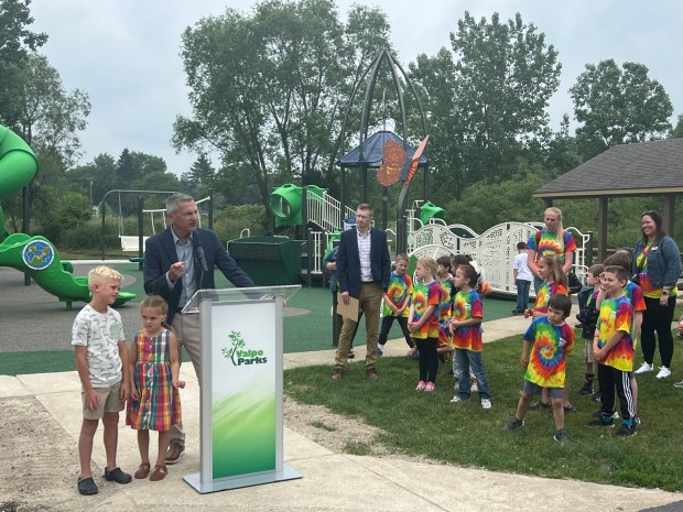 Valparaiso Mayor Jon Costas introduces his grandchildren, Bill and Ellen, to the assembled 200 park patrons on Friday, June 6, 2025, during the ribbon cutting and opening of the new Foundation Meadows Park space in Valparaiso designed for all abilities. (Phil Potempa/Post-Tribune)