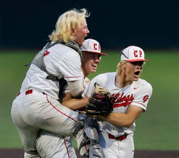 Crown Point's Logan Johnston celebrates with teammates Jase Horton and Jaxtyn Alexander
