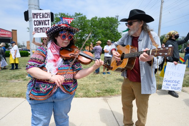 Musicians Angie Salva, on left, and Terry Schafer, who play under the name Terry and Angie, perform for fellow protesters during the "No Kings" rally in Highland on Saturday, June 14, 2025. (Kyle Telechan/for the Post-Tribune)