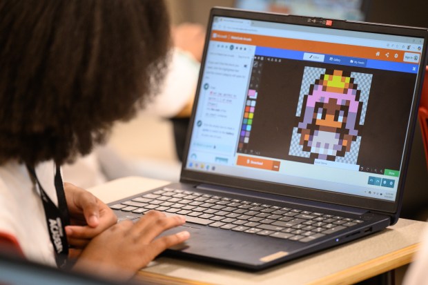 A student edits a character sprite as she learns to code and create a basic game during Indiana University Northwest's annual Kids College on Thursday, June 12, 2025. (Kyle Telechan/for the Post-Tribune)