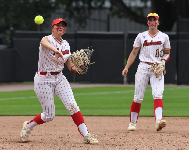 Andrean third baseman Maggie Voliva throws to first