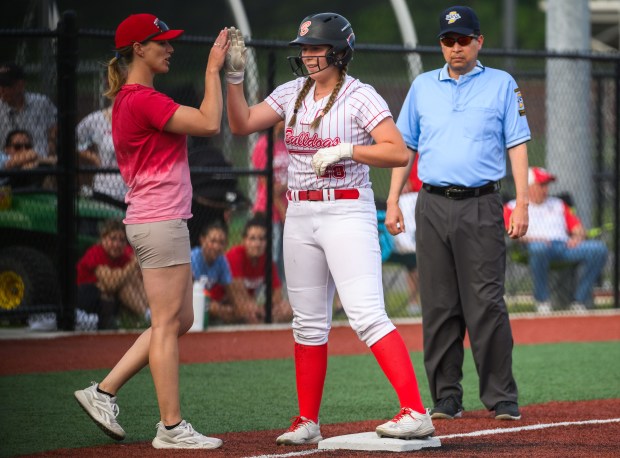 Crown Point coach Angie Richwalski high-fives Ashlyn Kita