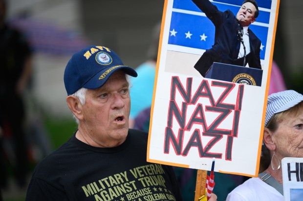 Vietnam War veteran Alan Dault, of DeMotte, holds up a sign and chants with other protesters during the NWI Activists "Ban Fascists Not Books" event in downtown Valparaiso on Friday, June 13, 2025. (Kyle Telechan/for the Post-Tribune)