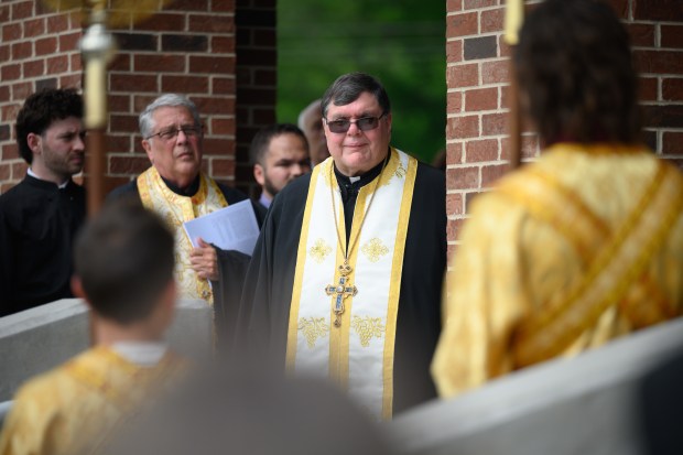 Presiding priest the Rev. Fr. James Greanias smiles during a Thyranoixia, or opening of the doors ceremony, for St. Iakovos Greek Orthodox church on Saturday, June 14, 2025. (Kyle Telechan/for the Post-Tribune)