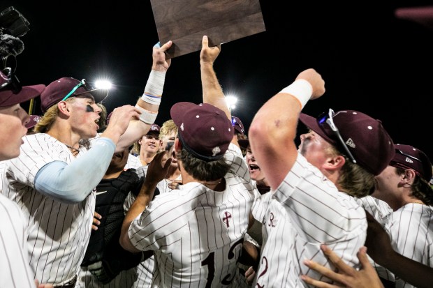 Brother Rice's Nolan Ramoley, left, and Brother Rice's Jackson Natanek (13) hold up the supersectional trophy after defeating Providence in the Class 4A Crestwood Supersectional at Ozinga Field in Crestwood on Monday, June 9, 2025. (Vincent D. Johnson / for the Daily Southtown)