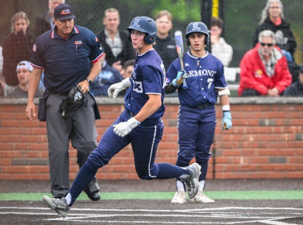 Lemont senior Shea Glotzbach (23) runs across home after scoring a run off a wild throw during the Lemont vs. Oak Forest Class 3A St. Laurence Sectional baseball semifinal in Burbank, IL on Thursday, June 5, 2025. (Andrew Burke-Stevenson/for the Daily Southtown)