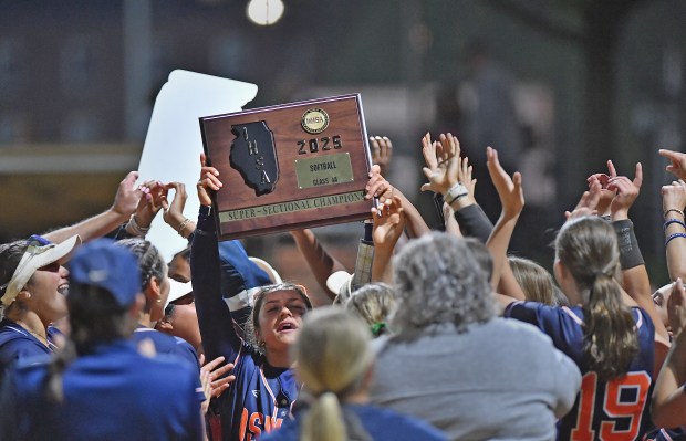 Oswego's Kiyah Chavez holds up the Supersectional championship plaque after defeating Marist in the Class 4A Benedictine Supersectional game on Monday, June 9, 2025 in Lisle.(Jon Cunningham for the Daily Southtown)