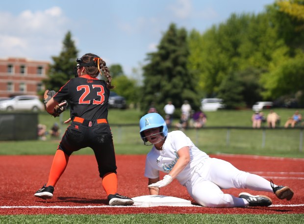 Joliet Catholic's Addison Rizzatto (8) beats out a tag by Beecher's Tayiah Scanlan (23) at third base during the Class 2A Joliet Catholic Regional at Lewis University in Romeoville on Saturday, May 18, 2024. (Trent Sprague/for the Daily Southtown)