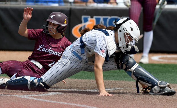 Oak Park River Forest's catcher Julia Mattiace (18) stretches as she catches the ball and gets the force out of Lockport's Marie Baranowski (2) at home. Oak Park River Forest defeated Lockport 6-5 in the Class 4A third-place game at the Louisville Slugger Sports Complex in Peoria, Saturday, June 14, 2025. (Rob Dicker / for the Daily Southtown)