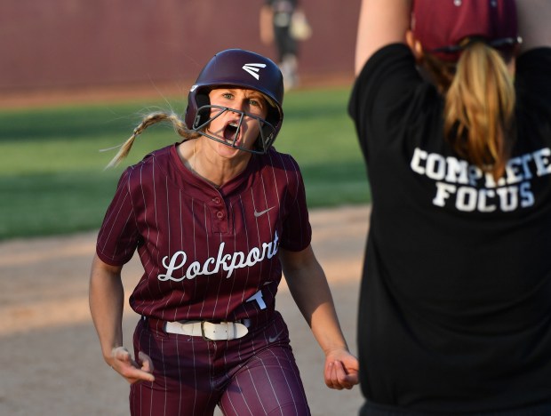 Lockport's Rheanna Slavicek shouts to the bench from third base after hitting an RBI triple in the tenth inning against Lincoln-Way Central during the Class 4A Lockport Sectional final game on Friday, June 6, 2025 in Lockport.(Jon Cunningham for the Daily Southtown)