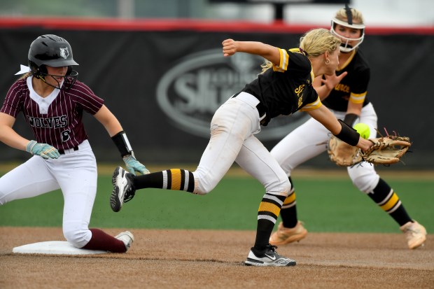 St. Laurence High School's Demi Lotus (5) can't get the ball but St. Laurence High School's Aoibhe Landers (1) hacks her up as Prairie Ridge's Adysen Kiddy (8) steals second base. St. Laurence fell to Prairie Ridge 12-0at the Louisville Slugger Sports Complex in Peoria, Class 3A third-place game, Saturday, June 14, 2025. (Rob Dicker / for the Daily Southtown)