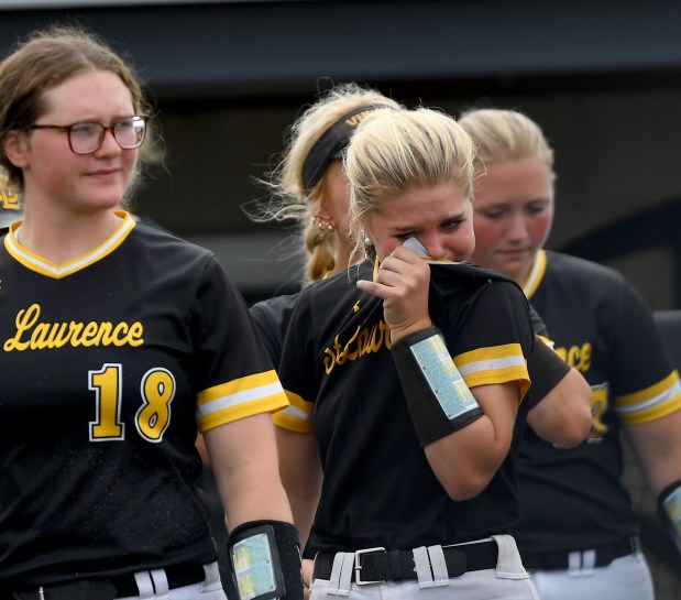 St. Laurence High School's Aoibhe Landers (1) wipes a tear from her eyes as she walks out of the dugout to shake hands with their opponent. St. Laurence fell to Prairie Ridge 12-0 at the Louisville Slugger Sports Complex in Peoria, Class 3A third-place game, Saturday, June 14, 2025. (Rob Dicker / for the Daily Southtown)