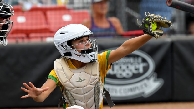 Providence Catholic's catcher Mia Sanfratello (12) stops a high pitch. Providence Catholic defeated St. Laurence 5-2 at the Louisville Slugger Sports Complex in Peoria, Class 3A state semifinals, Friday, June 13, 2025. (Rob Dicker / for the Daily Southtown)