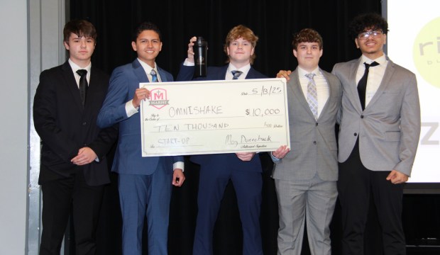 OmniShake team members show off up their winning check on pitch night at Marist High School. The students, who dressed professionally to present their product, are Sean Carroll, left, Devin Feliciano, Colin Vucko, Danny Kelly and Sameer Tadros. (Marist High School)